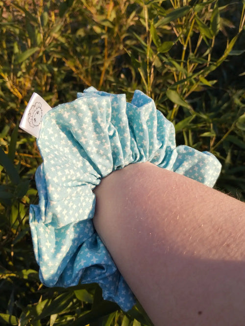 Aqua Stitch Jumbo Scrunchie worn on a wrist to show its size