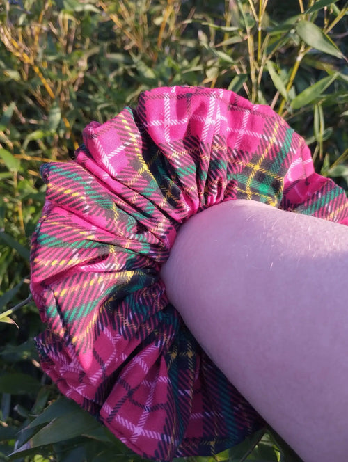 Berry Tartan Jumbo Scrunchie worn on a wrist to show its size