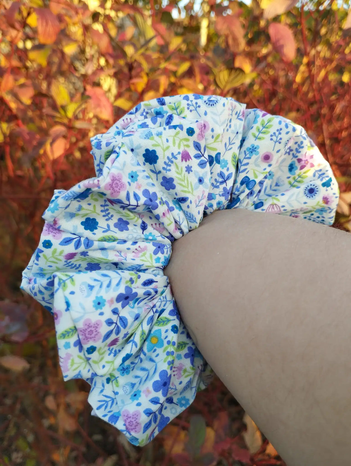 Bluebell Meadow Jumbo Scrunchie worn on a wrist to show its size