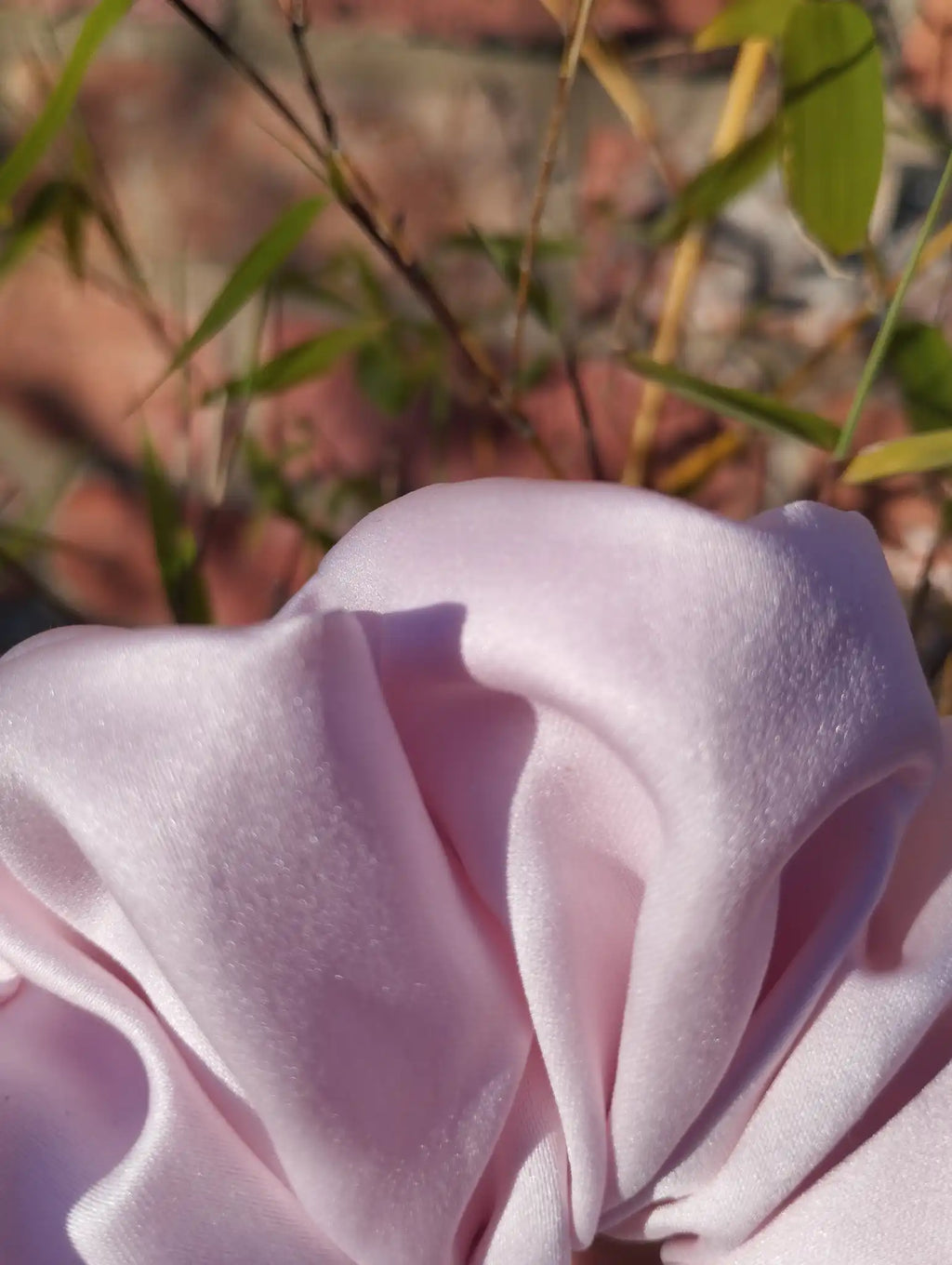Close-up of the pale blush pink satin fabric and sheen on Blush Pink Jumbo scrunchie
