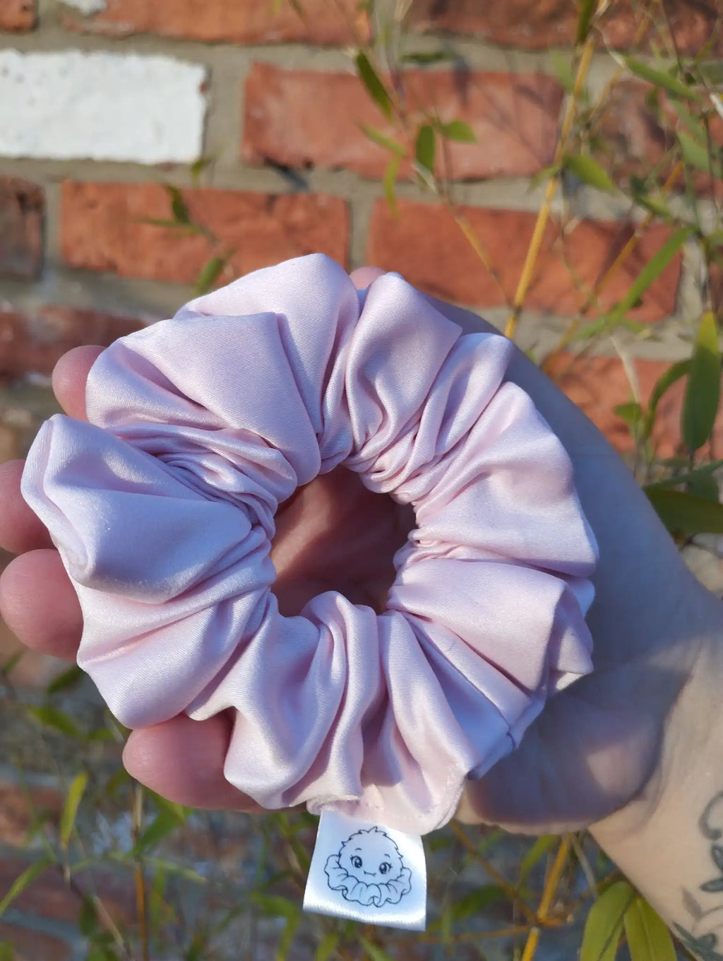 Blush Pink satin Medium scrunchie showing its gathered shape