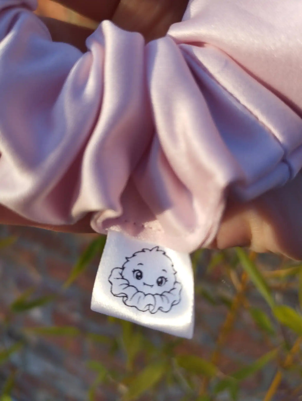 Scrunchlings character label and stitching on Blush Pink satin Medium scrunchie