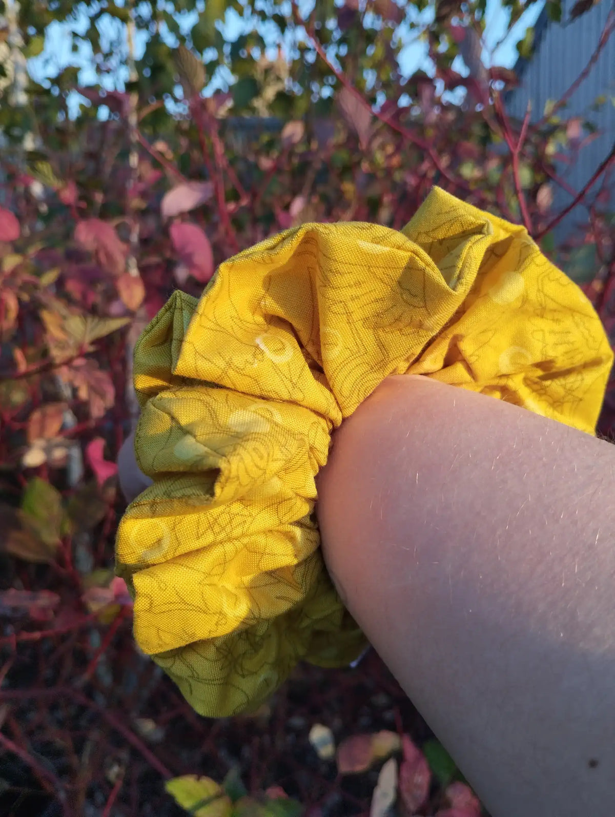Buttercup Jumbo Scrunchie worn on a wrist to show its size