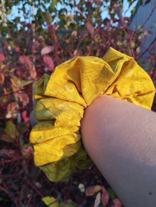 Buttercup Jumbo Scrunchie worn on a wrist to show its size