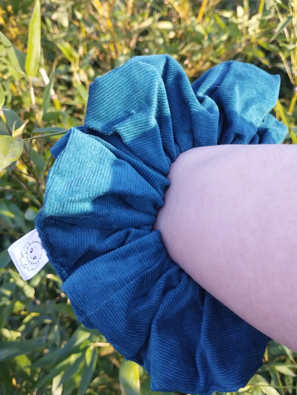 Deep Teal Jumbo Scrunchie worn on a wrist to show its size