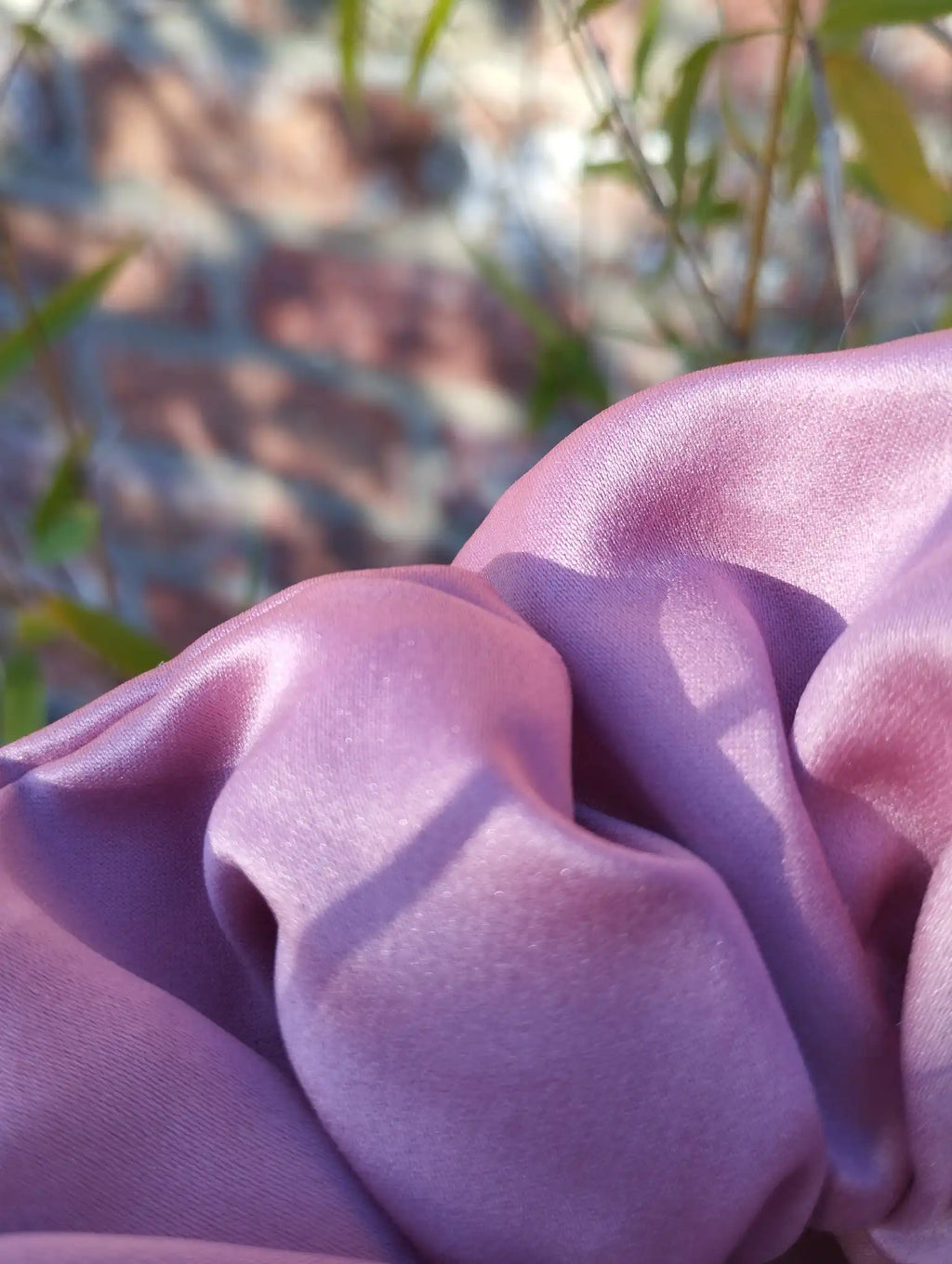 Close-up of the dusky rose pink satin fabric and sheen on Dusky Rose Jumbo scrunchie