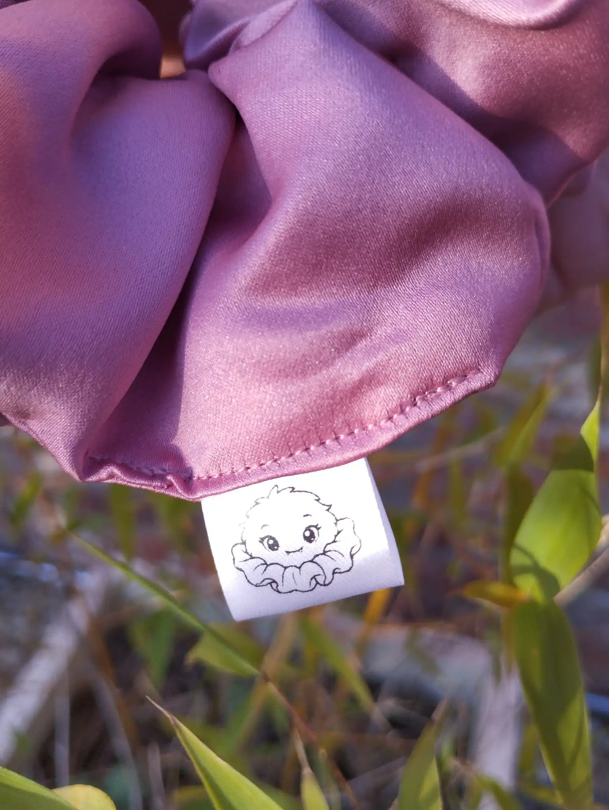 Scrunchlings character label and stitching on Dusky Rose satin Jumbo scrunchie