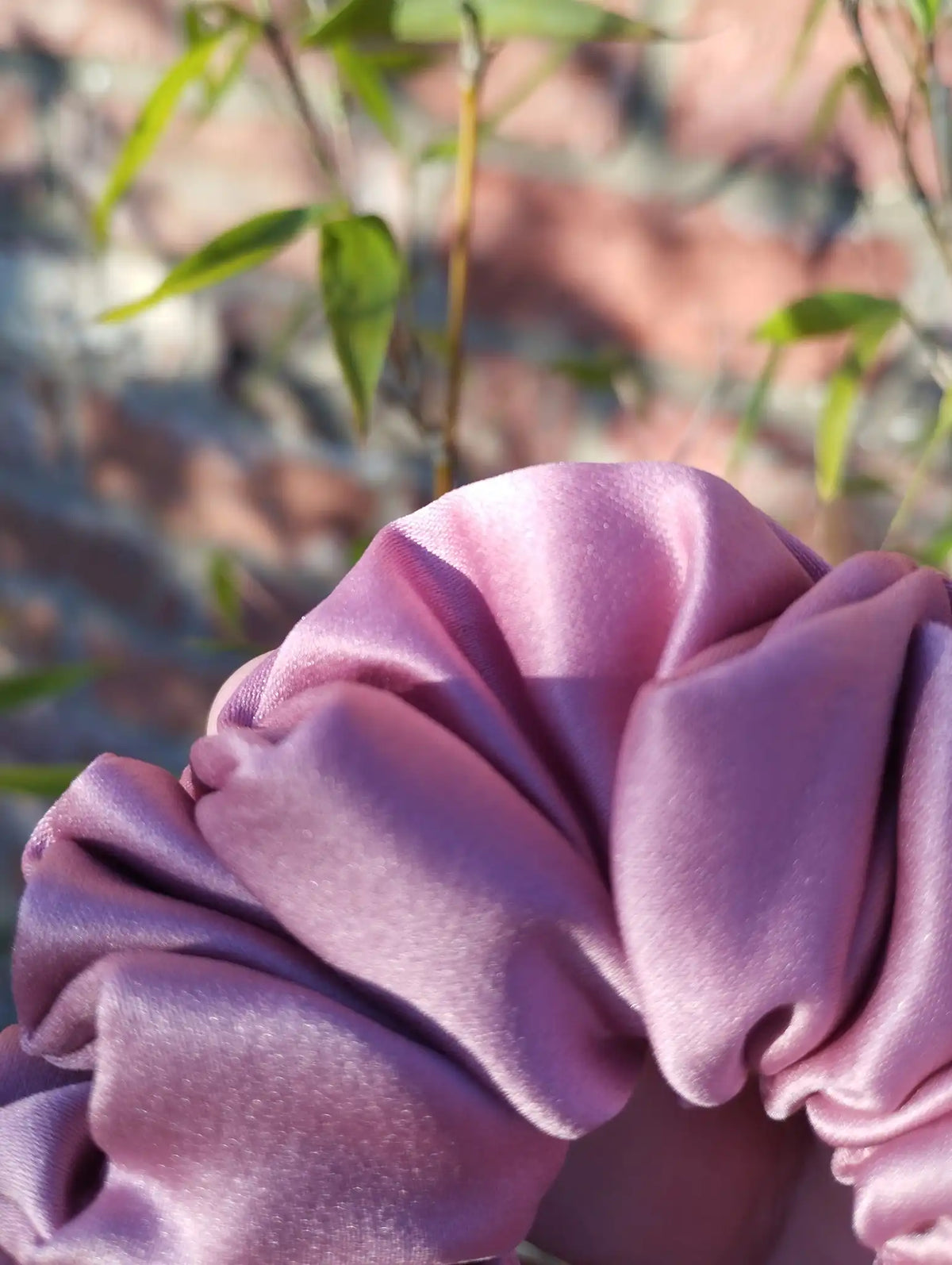 Close-up of the dusky rose pink satin fabric on Dusky Rose Medium scrunchie