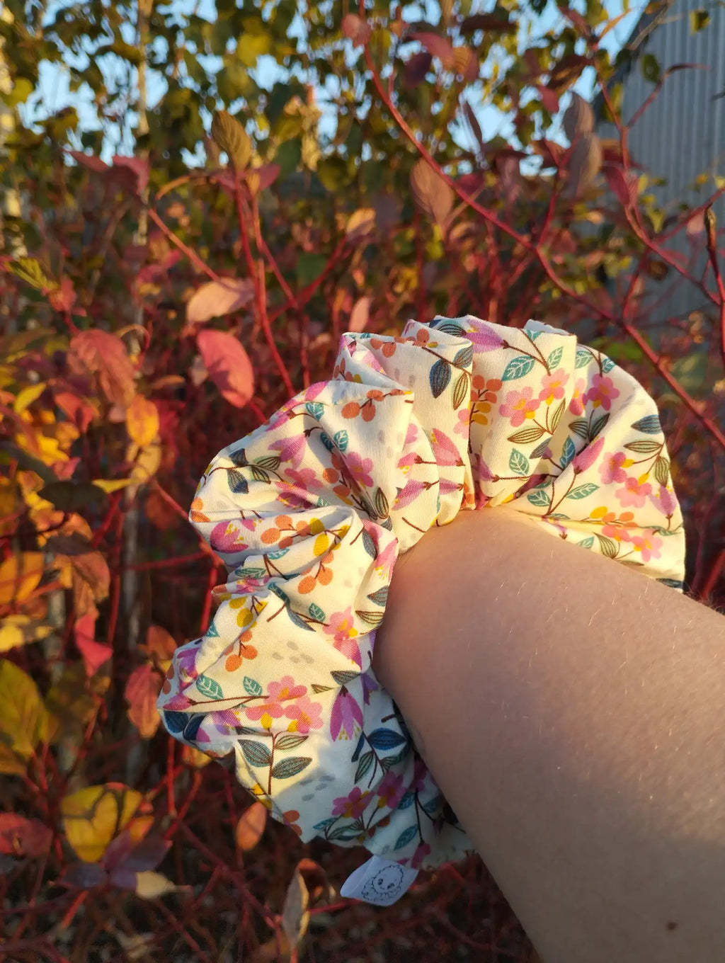 Garden Party Jumbo Scrunchie worn on a wrist to show its size