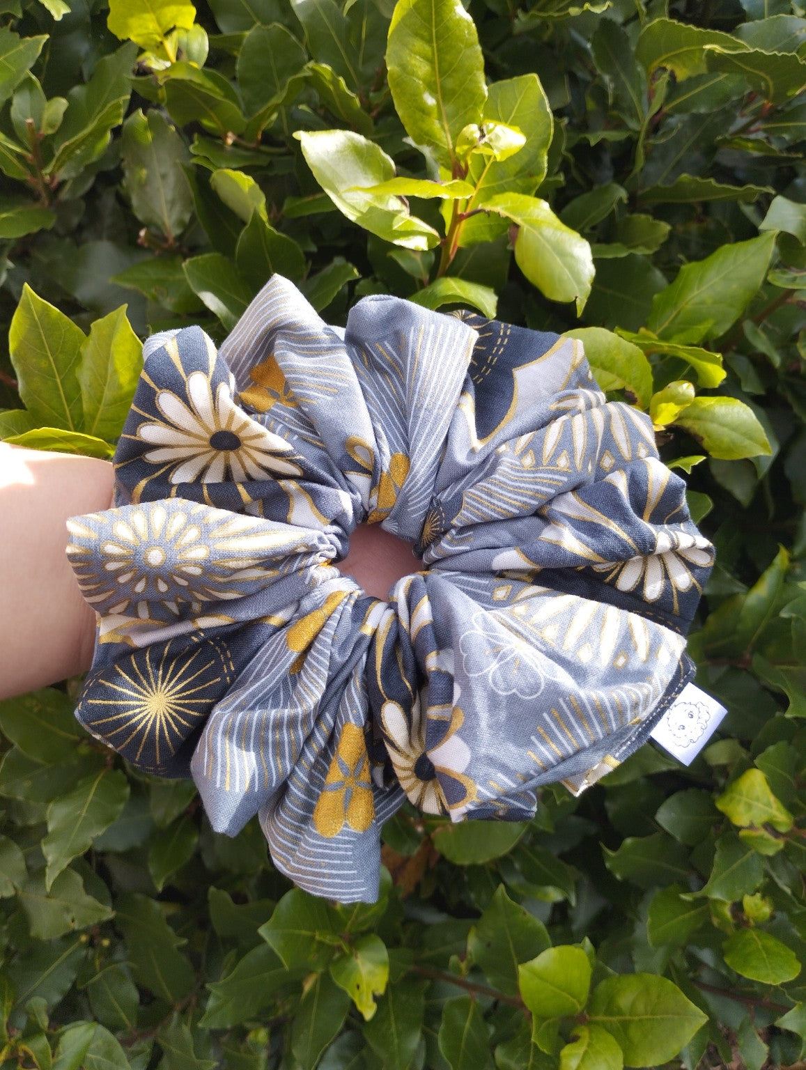 Golden Meadow Super Jumbo scrunchie with blue-grey, cream and gold floral print, front view