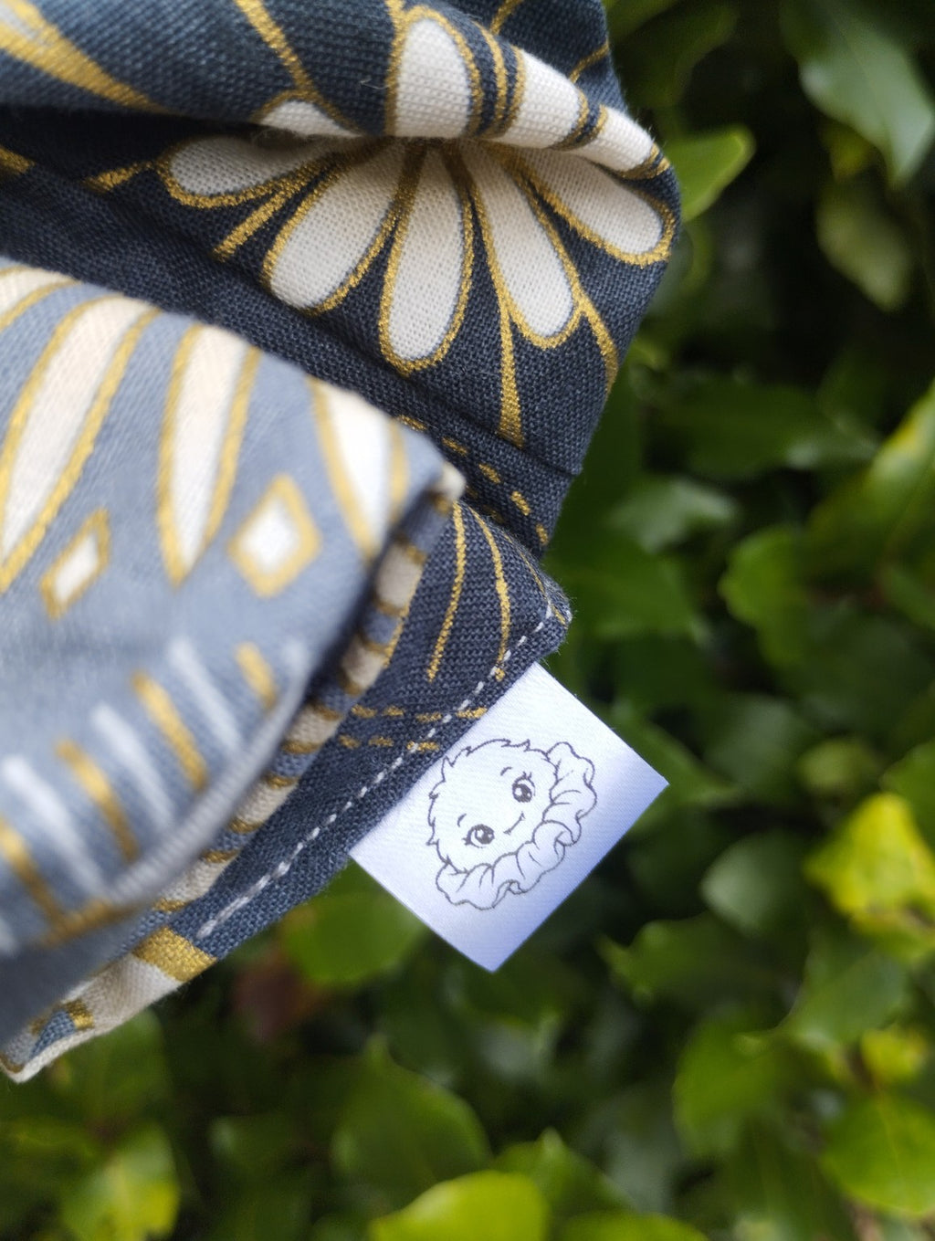 Golden Meadow floral scrunchie stitching and Scrunchlings character label