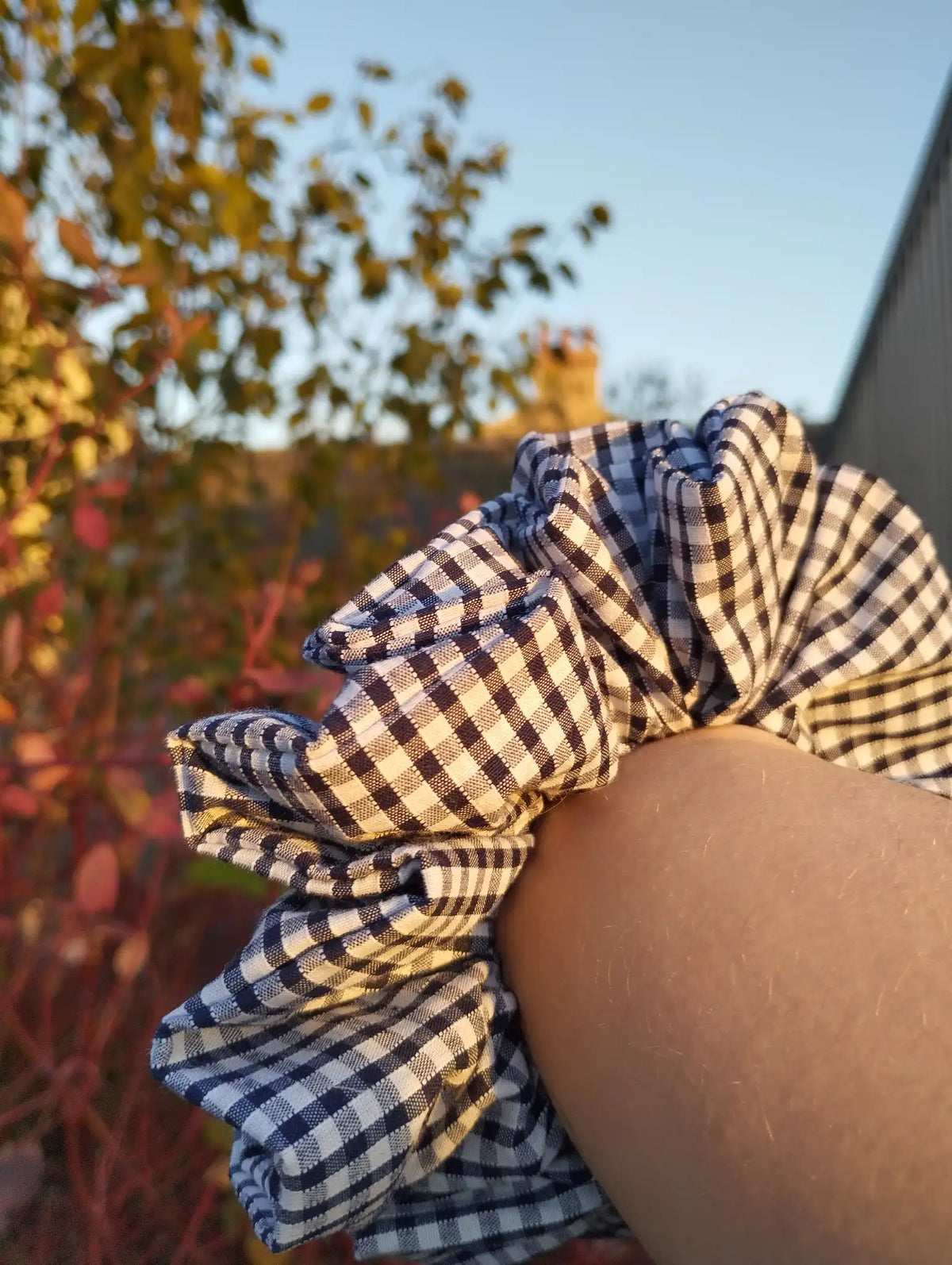 Ink Gingham Jumbo Scrunchie worn on a wrist to show its size