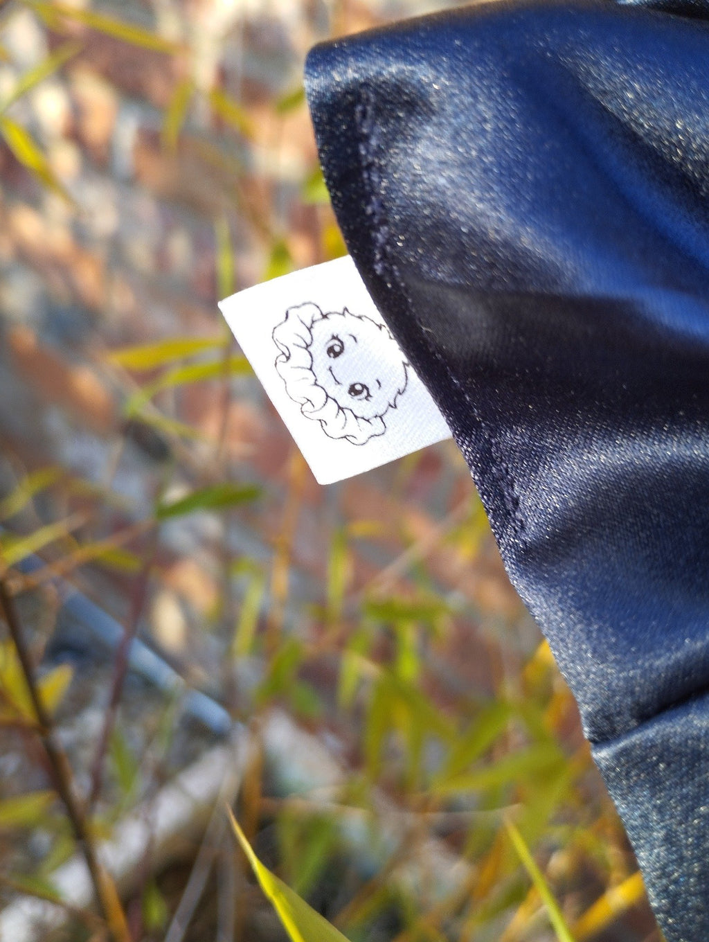 Close-up of the Scrunchlings character label on Midnight Blue Satin Super Jumbo scrunchie