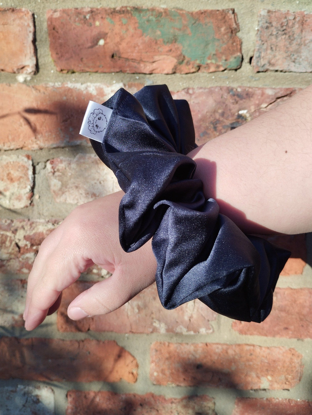 Midnight Blue Satin Super Jumbo scrunchie worn on a wrist to show its oversized proportions