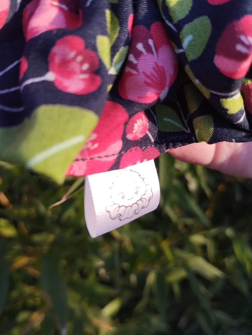 Scrunchlings character label and stitching on Midnight Poppies Jumbo Scrunchie
