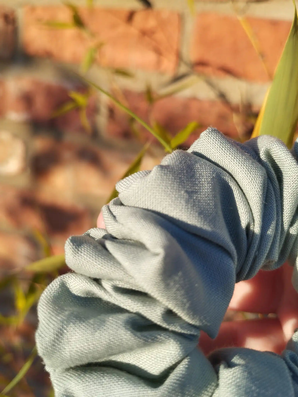 Close-up of the muted sage green cotton fabric on Sage Green Medium scrunchie