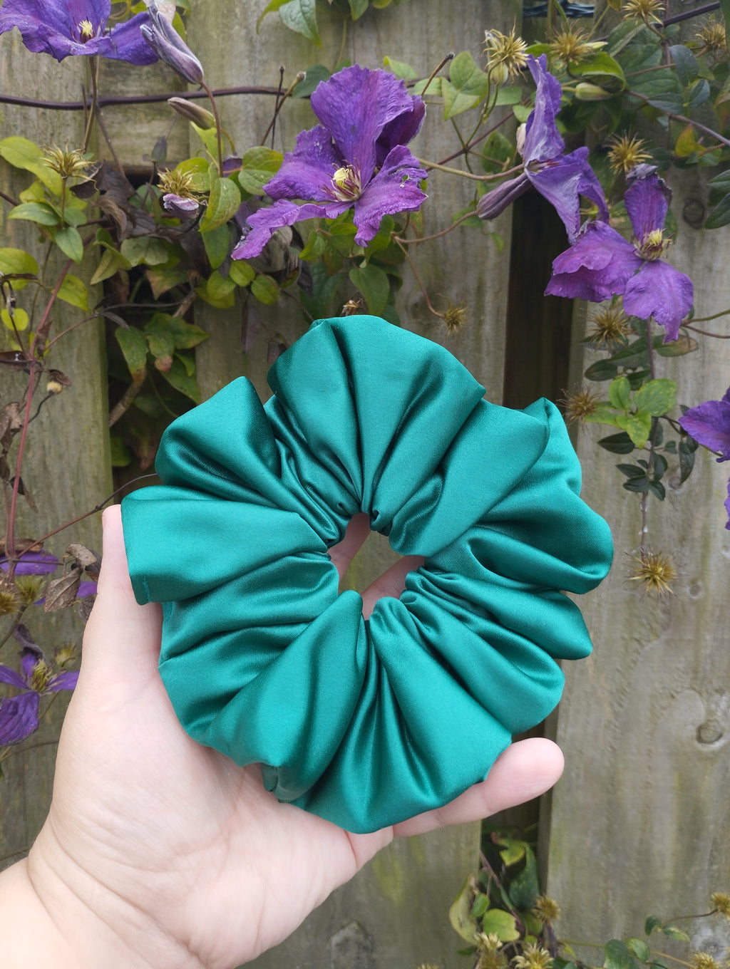 Kingfisher Jade teal jumbo satin scrunchie held in a hand