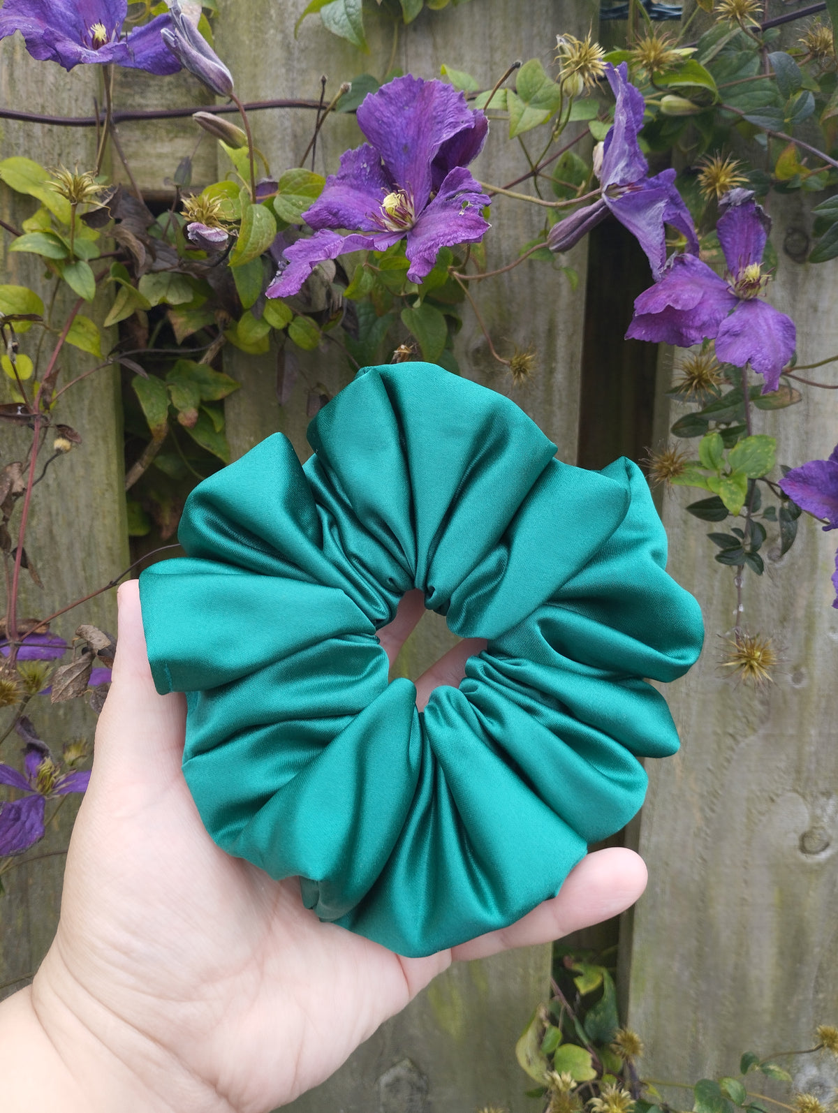 Kingfisher Jade teal jumbo satin scrunchie held in a hand