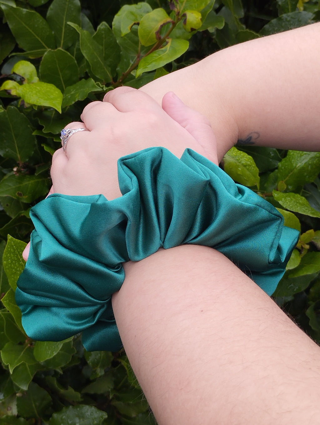 Kingfisher Jade teal jumbo satin scrunchie worn on a wrist