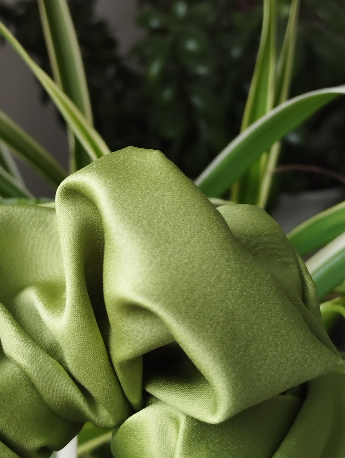 Moss green jumbo satin scrunchie fabric close-up