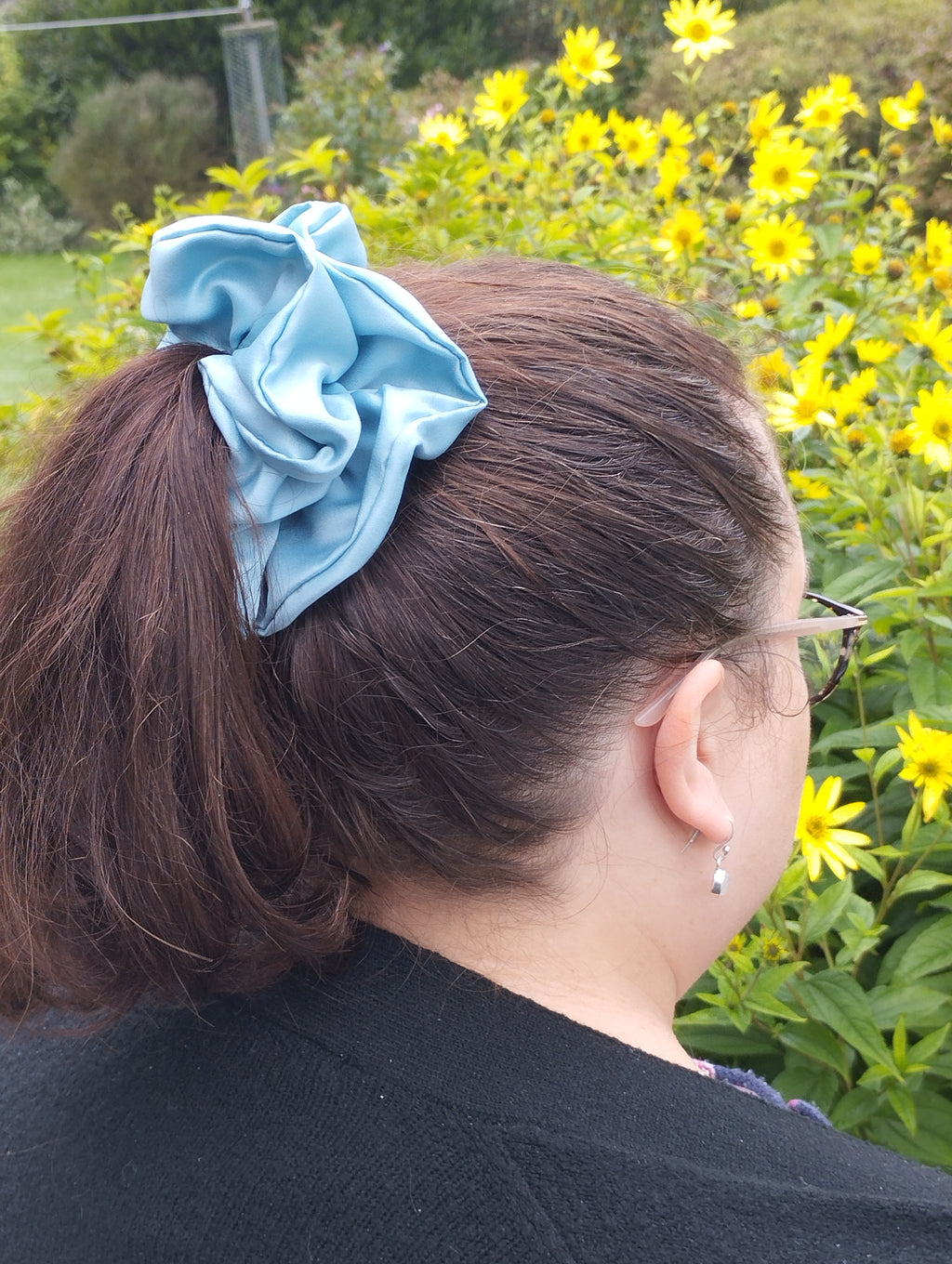October Sky light blue jumbo satin scrunchie worn in a ponytail