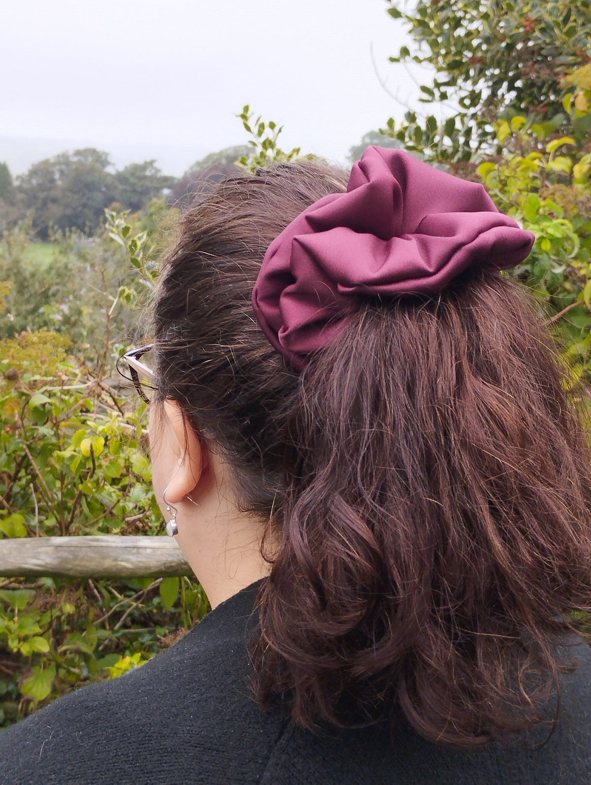 Ruby burgundy jumbo satin scrunchie worn in a ponytail