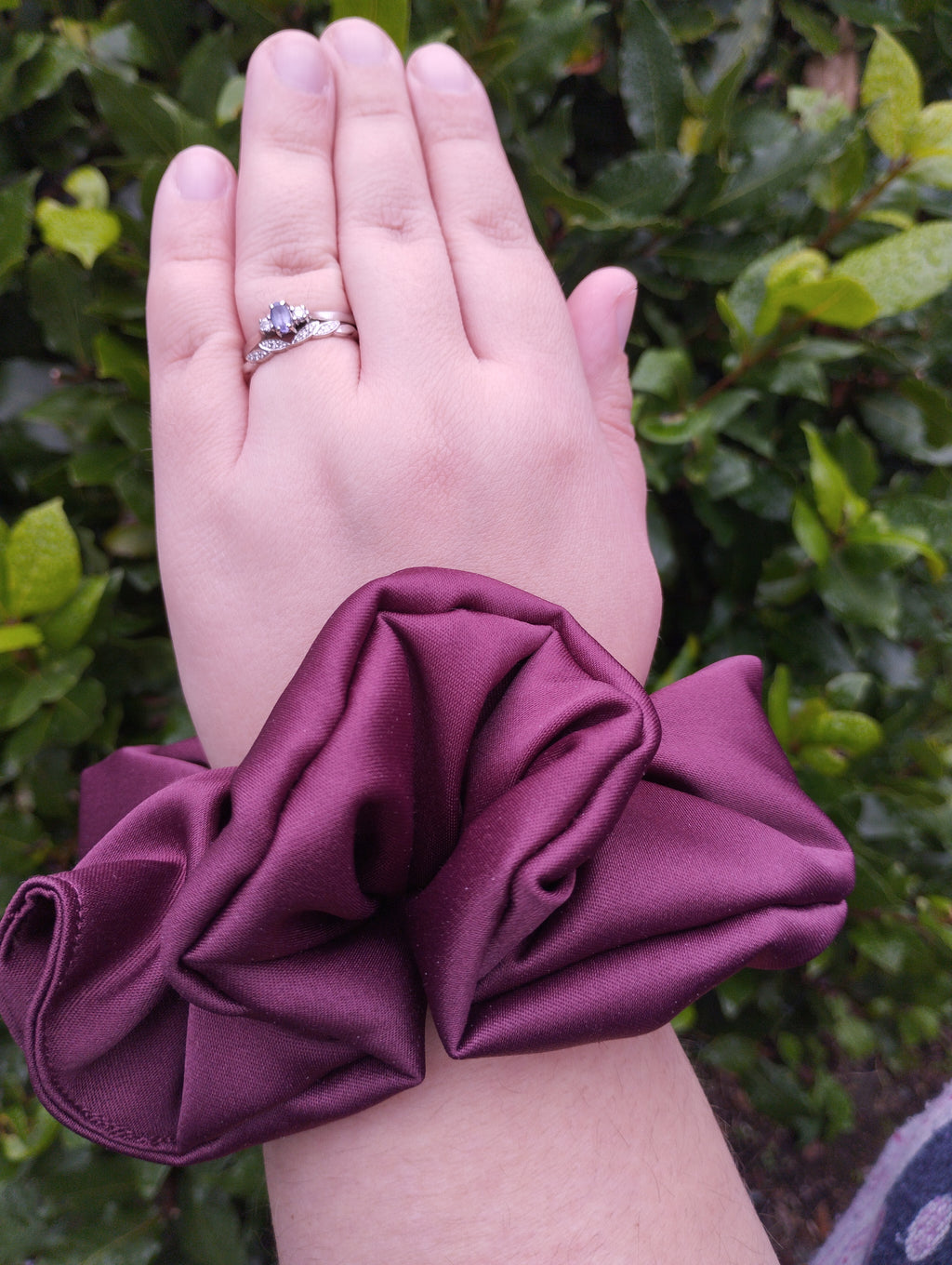 Ruby burgundy jumbo satin scrunchie worn on a wrist