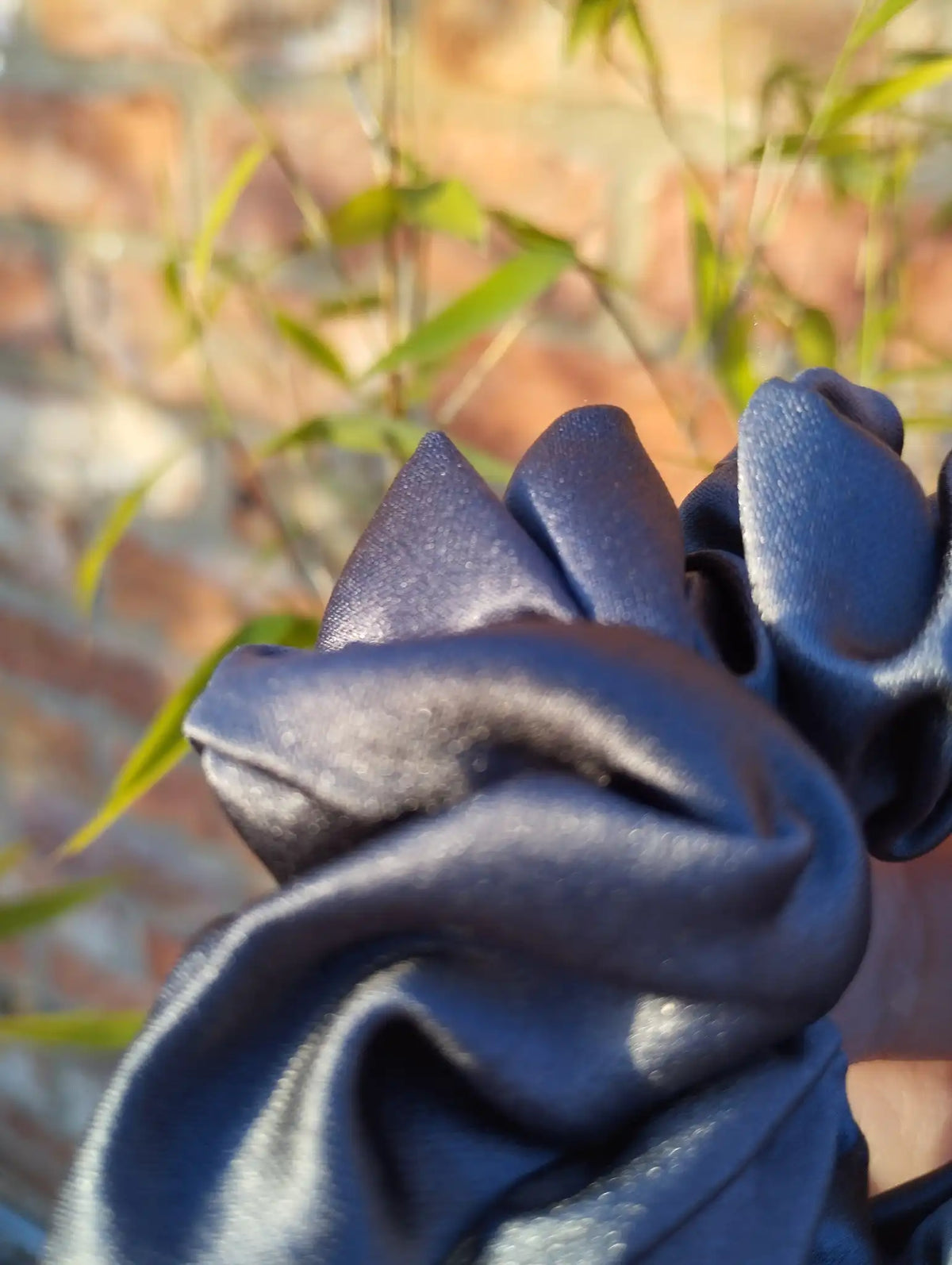 Close-up of the slate grey satin fabric on Slate Grey Medium scrunchie