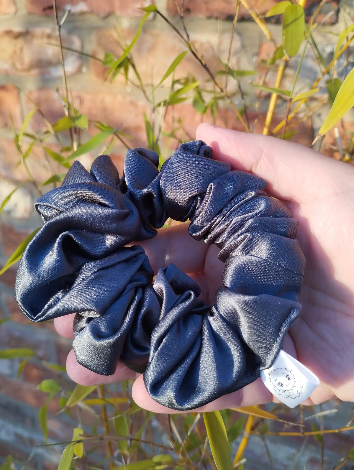 Slate Grey satin Medium scrunchie showing its gathered shape