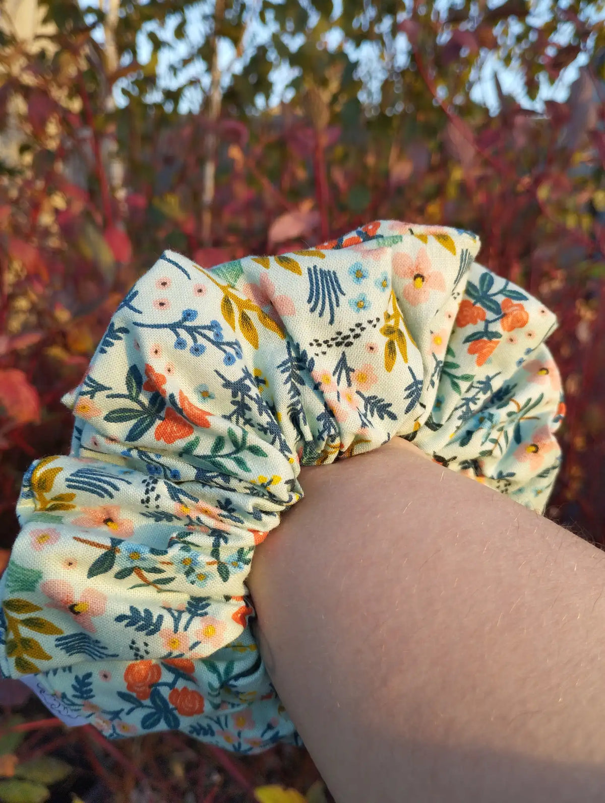 Soft Meadow Jumbo Scrunchie worn on a wrist to show its size