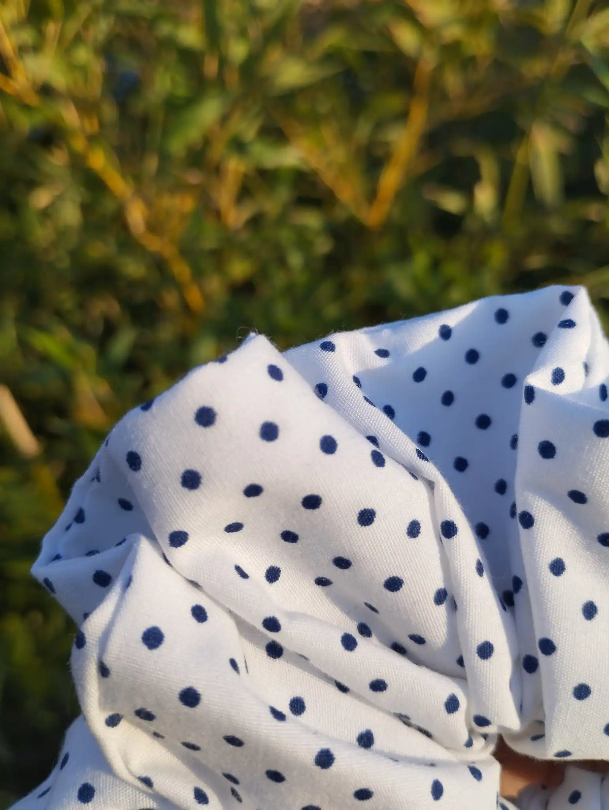 Close-up of the fabric texture and pattern on Speckle Dot Jumbo Scrunchie