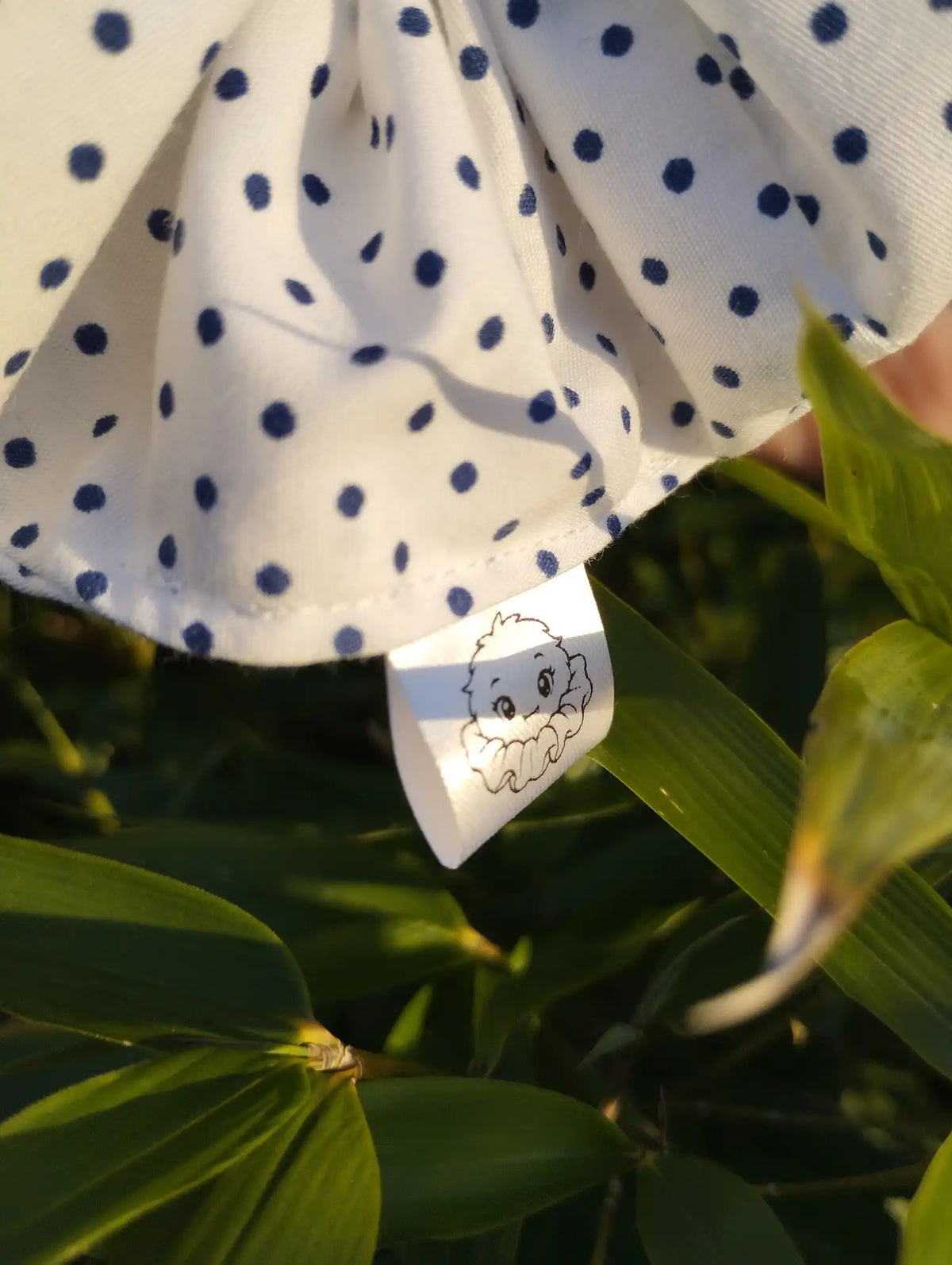 Scrunchlings character label and stitching on Speckle Dot Jumbo Scrunchie