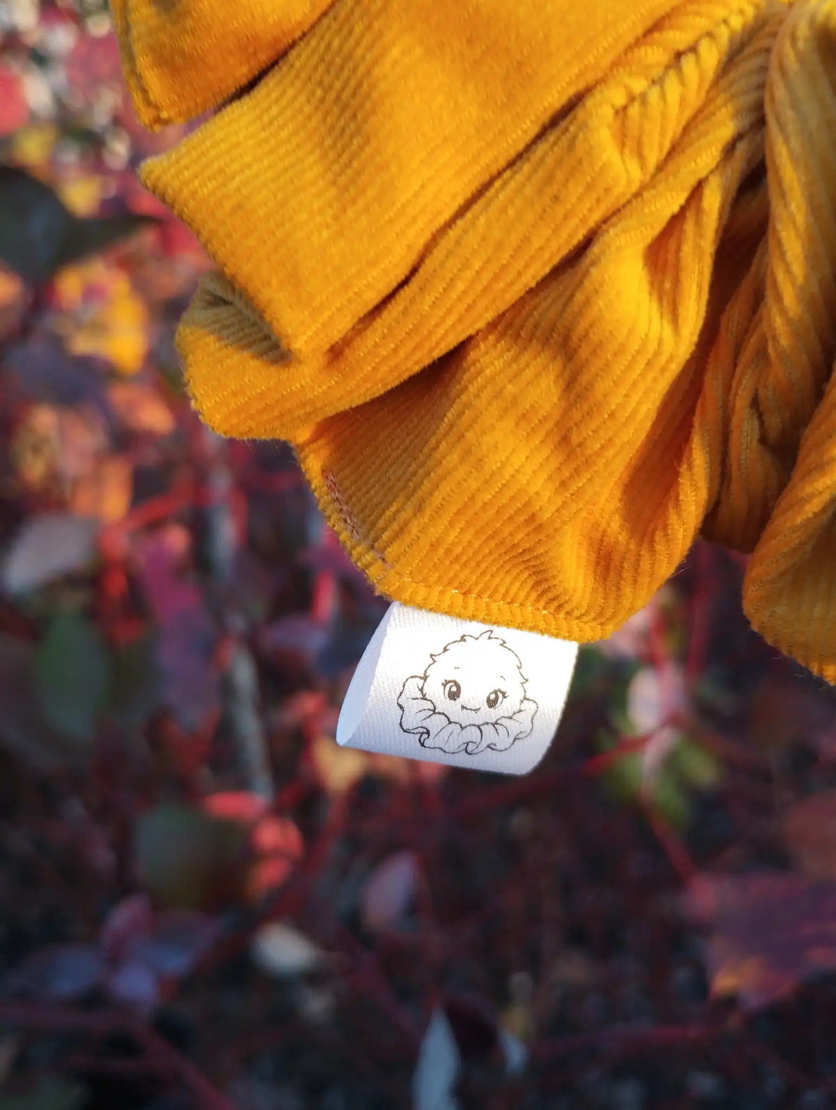 Scrunchlings character label and stitching on Sunflower Gold Jumbo Scrunchie