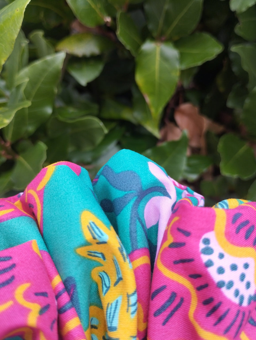 Close-up of the teal, pink and yellow floral fabric on Tropical Bloom Super Jumbo scrunchie