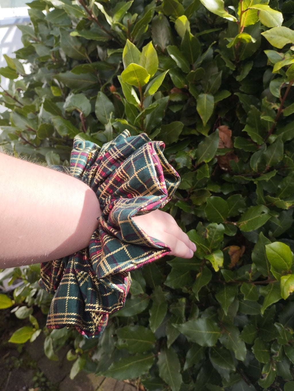 Woodland Tartan oversized checked scrunchie worn on a wrist to show its size