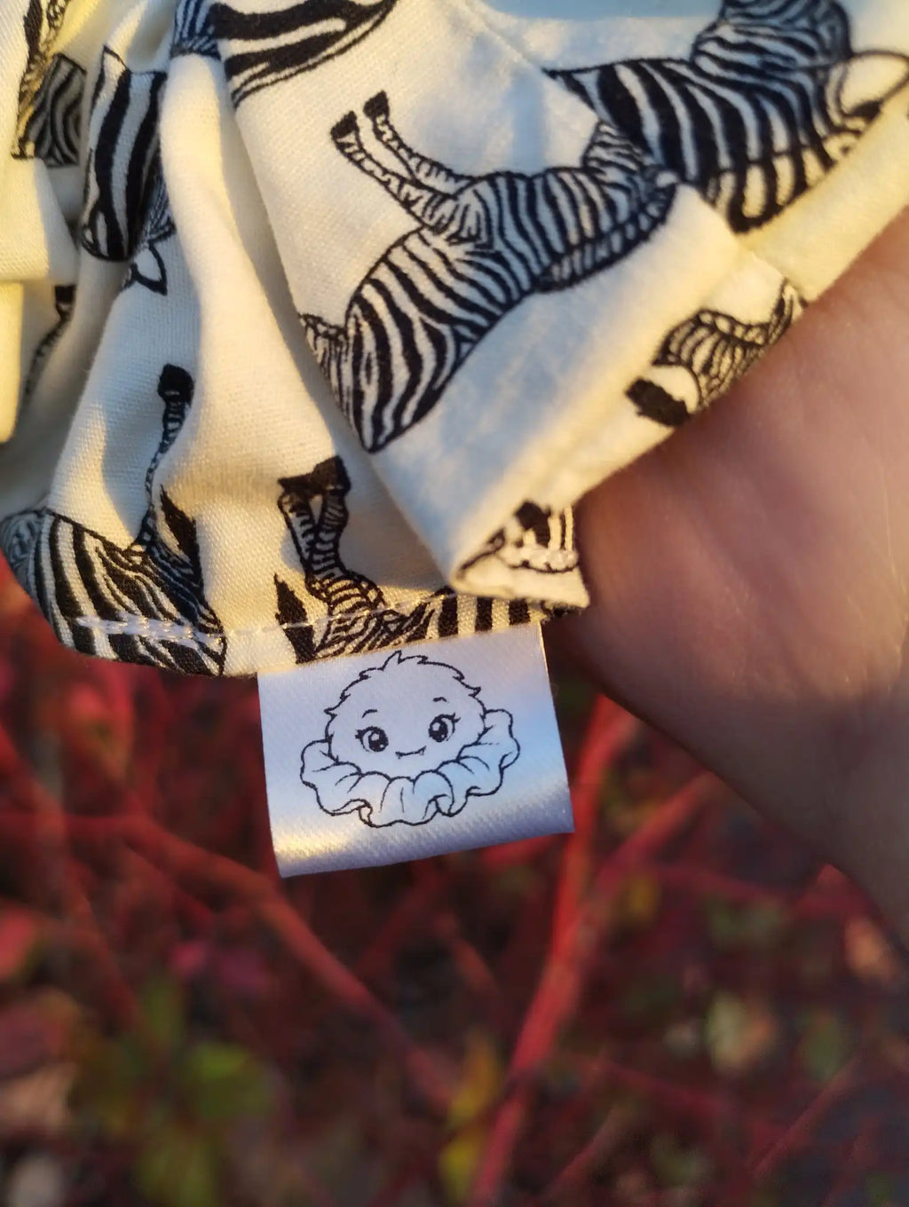 Scrunchlings character label and stitching on Zebra Parade Jumbo Scrunchie